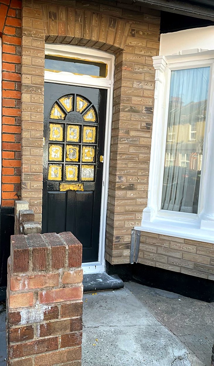 Terraced house frontage finished in brick-effect render