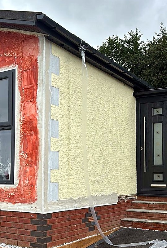 Bungalow walls part-way through insulation and render